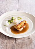 Pan-fried duck foie gras escalope with baby broad beans,green cardamon foamy sauce