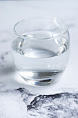 Glass of water on a marble background