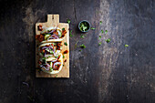 Bao bun, Asian steamed bun sandwich with spicy pork, cucumber and red onion