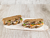 Baltic bread sandwich with smoked salmon, spinach, fromage frais, cucumber and onion