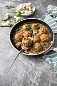 Veal meatballs with mushrooms, onion, garlic, parmesan, coriander, parsley and cream