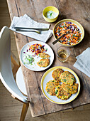 Savoury pancakes with herbs and grated carrot salad with white and red cabbage