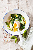 Asian broth with egg, pack choi cabbage, lemongrass, basil and ginger