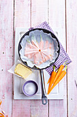 Add the carrots, salt and butter to a frying pan, cover with water and greaseproof paper and cook until done
