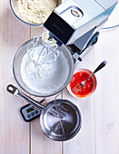 Whisk the egg whites until stiff and add the red colouring