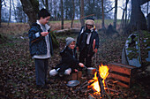Children cooking on a campfire
