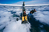Two parachutists in ultralight airplane