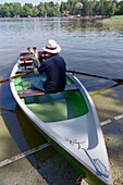 Man with dog in Boat, Staffelsee, Bavaria, Germany