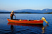Fisherman in his boat, Staffelsee, Murnau, Upper Bavaria, Germany