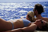 People sunbathing on a sailing boat, Caribbean, America