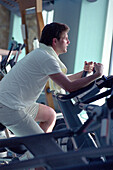 Man training at the gym of cruise ship AIDA