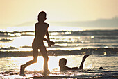 Children playing on seashore, Pentrez Plage, Brittany, France