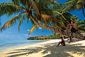 Couple sitting on the beach, Ile aux Nattes, Ste Marie, Madagascar