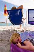 Sleeping Child on the beach, Sardinia, Italy