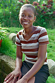 Woman sitting in her garden, St. Lucia, Caribbean