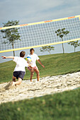 Sportiv men, people men playing beachvolleyball