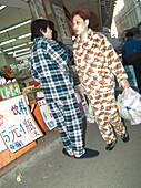 Couple with bags in pyjamas, people couple shopping, Shanghai, China