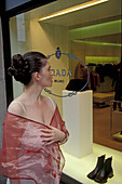 Woman looking at shop display, Residenzstrasse, Munich, Germany