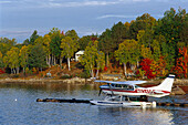 Wasserflugzeug auf dem Ambaisiers Lake vor herbstlichen Bäumen, Maine, USA, Amerika