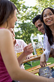 Four young people having fun in beer garden, Munich, Bavaria