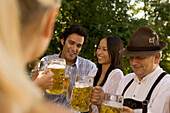 Friends toasting in beergarden, Bavaria, Germany