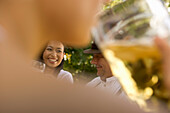 Three cheerful people with beer steins in beer garden, Munich, Bavaria