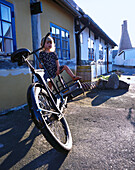 Girl 2-3 years, sitting on bicycle, Arsdale, Bornholm, Denmark