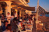 People sitting at Café del Mar in the light of the evening sun, San Antoni, Ibiza, Spain, Europe