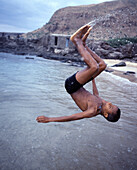Local boy performing a somersault into the sea, Vila Tarrafal, Santiago, Cape Verde Islands