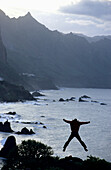 Silouette of a man jumping in the air, coast near Taganana, Anaga Mountains, Tenerife, Canary Islands, Spain