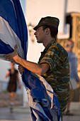 Young soldier with Greek Flag, Lykavittos Hill, Athens, Greece