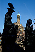 Close up of Schoener Brunnen with Our Ladys Church in the background, Nuremberg, Bavaria, Germany