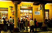 People standing in front of the bar Bodega Santa Cruz in the evening, Santa Cruz, Seville, Andalucia, Spain, Europe
