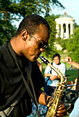 Saxophone player in English Garden at the Monopteros, Munich, Bavaria, Germany