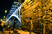 People climbing up a wall, Puente de Triana, Seville, Andalucia, Spain