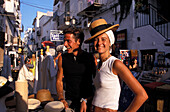 Young couple shopping for hats in Ibiza Town, Ibiza, Spain