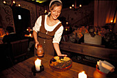 Waitress in medieval costume at Olde Hansa restaurant, Tallinn, Estonia, Europe