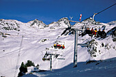 Skiers in chair lift, Ischgl, Tyrol, Austria