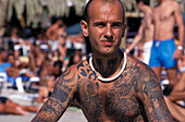 Man with tattoos, Sa Trincha, Platja de ses Salines, Ibiza, Balearic Islands, Spain