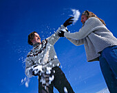 Couple having snowball fight