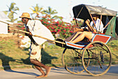 Girl sat in a rickshaw, Pousse-Pousse, Tamatave, Madagascar