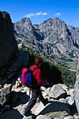 Woman hiking on route GR 20, Tightrope Walk, Resto a Valley, Corsica, France