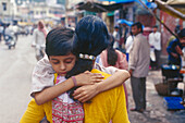 Woman with child on the street , Varanasi, Benares Uttar Pradesh, India