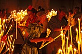 Pilgrims lighting candles, El Rocío, Andalusia, Spain