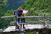 Couple looking at map, Jotunheimen NP, Western Middle Norway