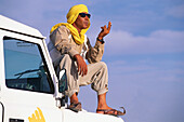 Chauffeur sitting on a jeep, Jeep Tour, Salt Desert, Chott el Djerid, Tunesia