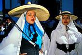 Two women in traditional clothes at the festival of the almond flower, Folklore music, Canary Islands, Spain