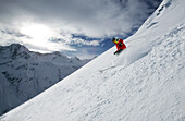 Person skiing in powder snow, Free Skiing, Ballunspitze, Wirl near Galtuer, Tyrol, Austria