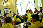 Group of cyclists in a restaurant, Porto Christo, Majorca, Balearic Islands, Spain