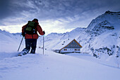 Man snowshoeing to ski hut, Stubai Alps, Austria